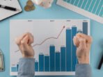 top-view-business-items-with-growth-chart-hands-fists-765x510